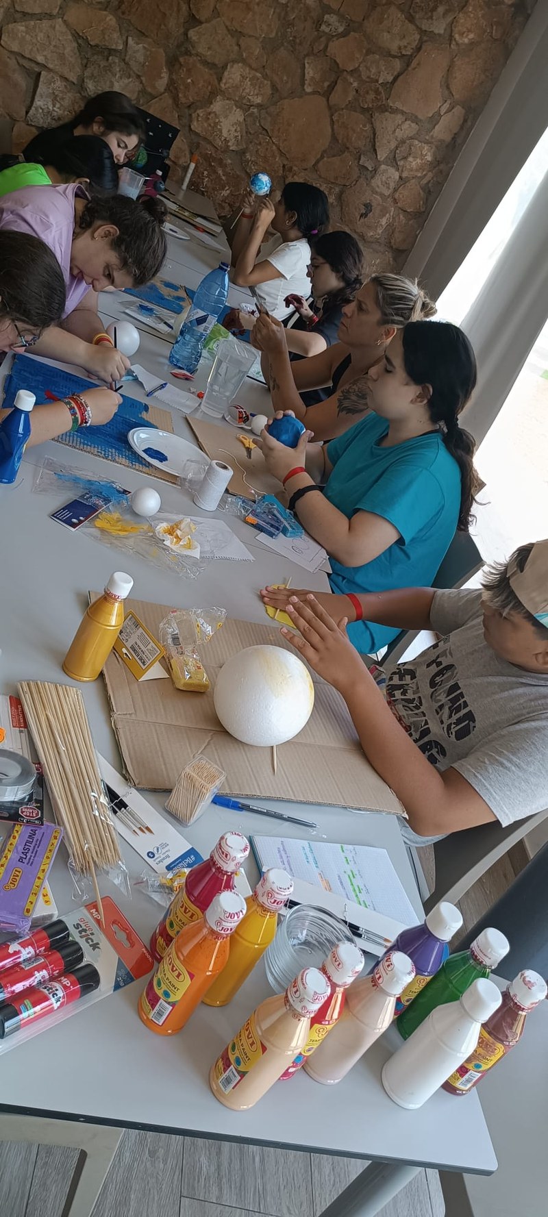 El grupo de participantes pinta planetas en uno de los talleres científicos 2.