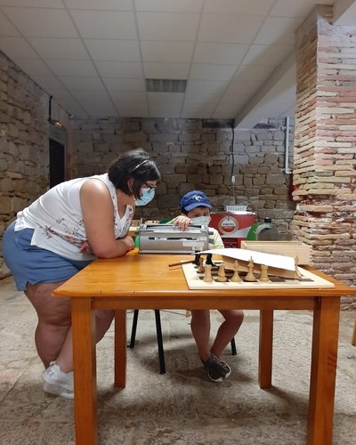 Dos participantes manejan la máquina Perkins Dos participantes manejan la máquina Perkins