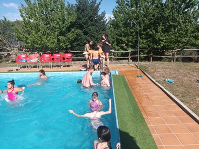 Varios participantes se bañan en la piscina