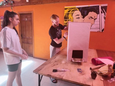 Un monitor y una participante decorando el buzón "Tropezón"