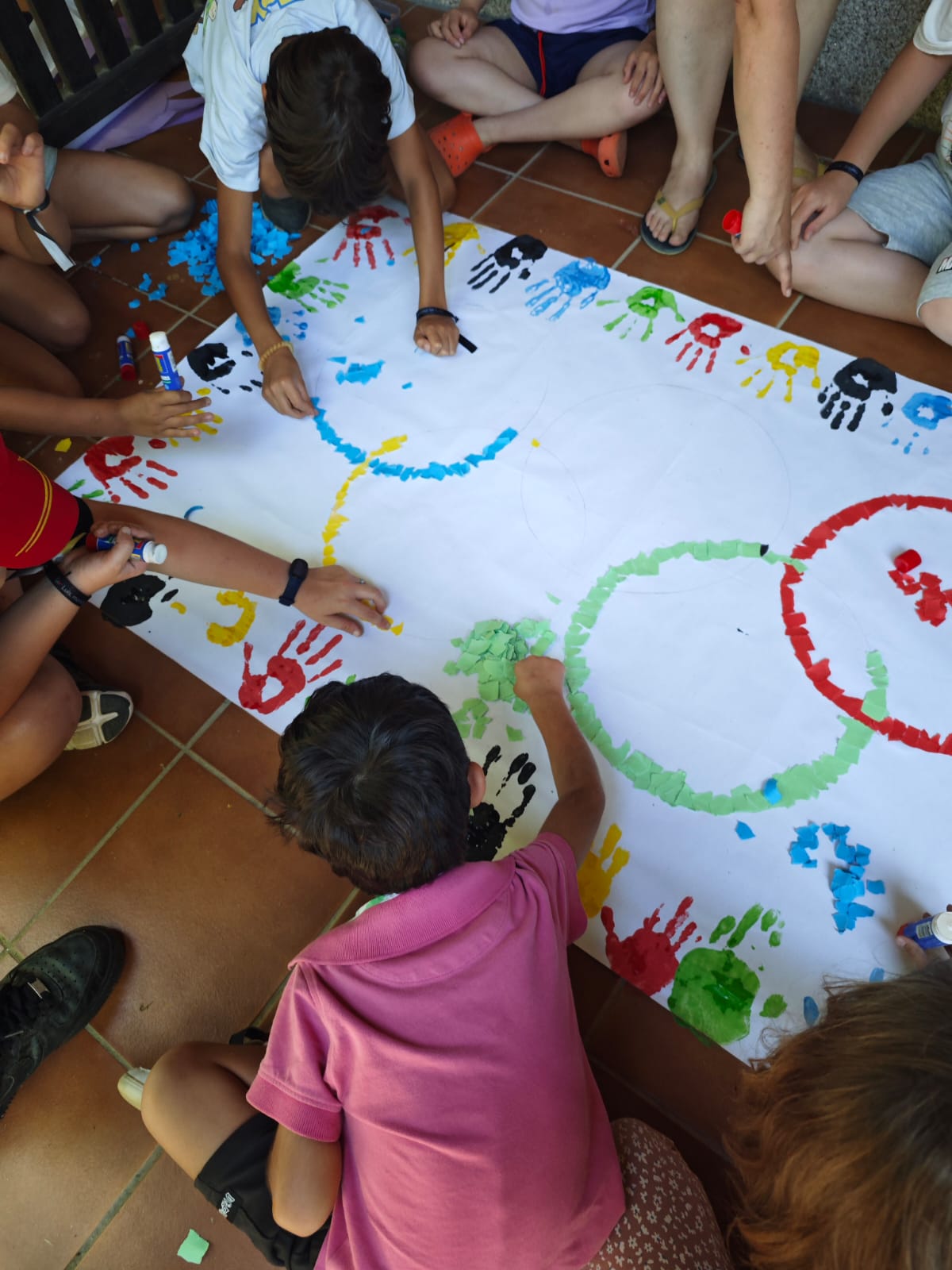 Participantes colaborando en la elaboración del mural olímpico.