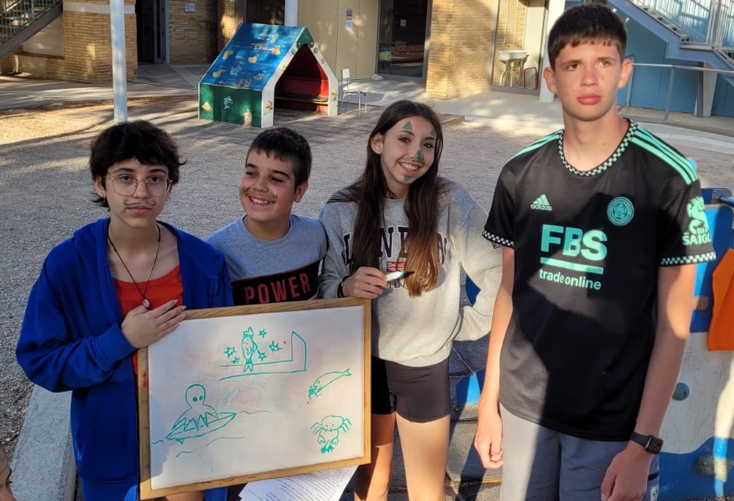 Grupo de participantes mostrando los dibujos que han realizado en una actividad